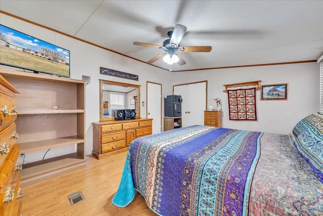 a view of an empty room with a ceiling fan