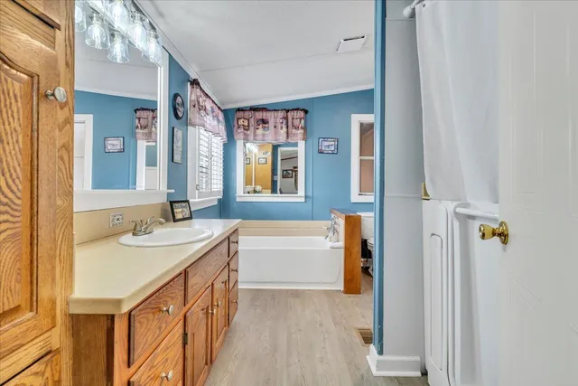 a view of empty room with window and ceiling fan