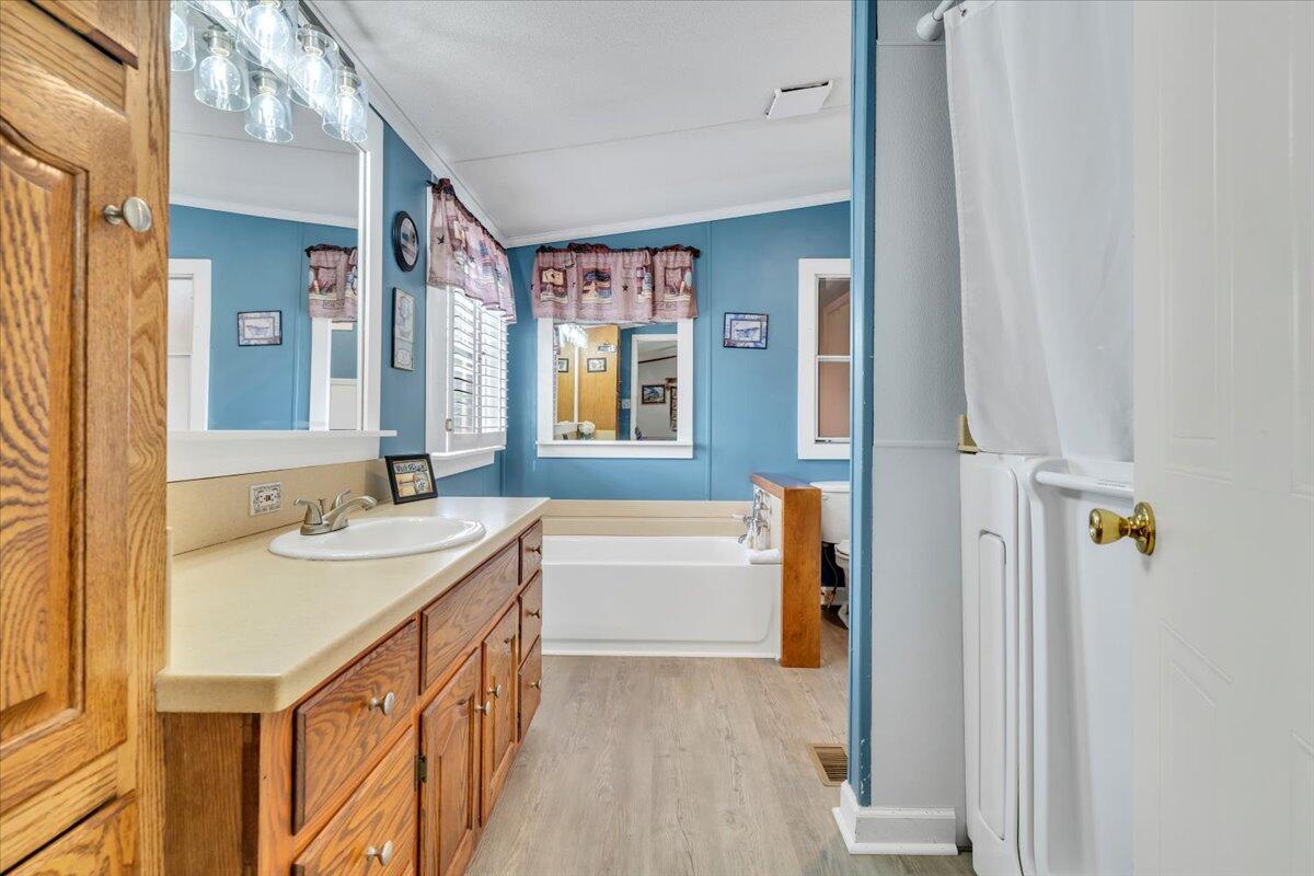 627-641 Novelty Road Penhook, VA 24137 - Photo 27 of 69 a bathroom with a sink a mirror and a bathtub
