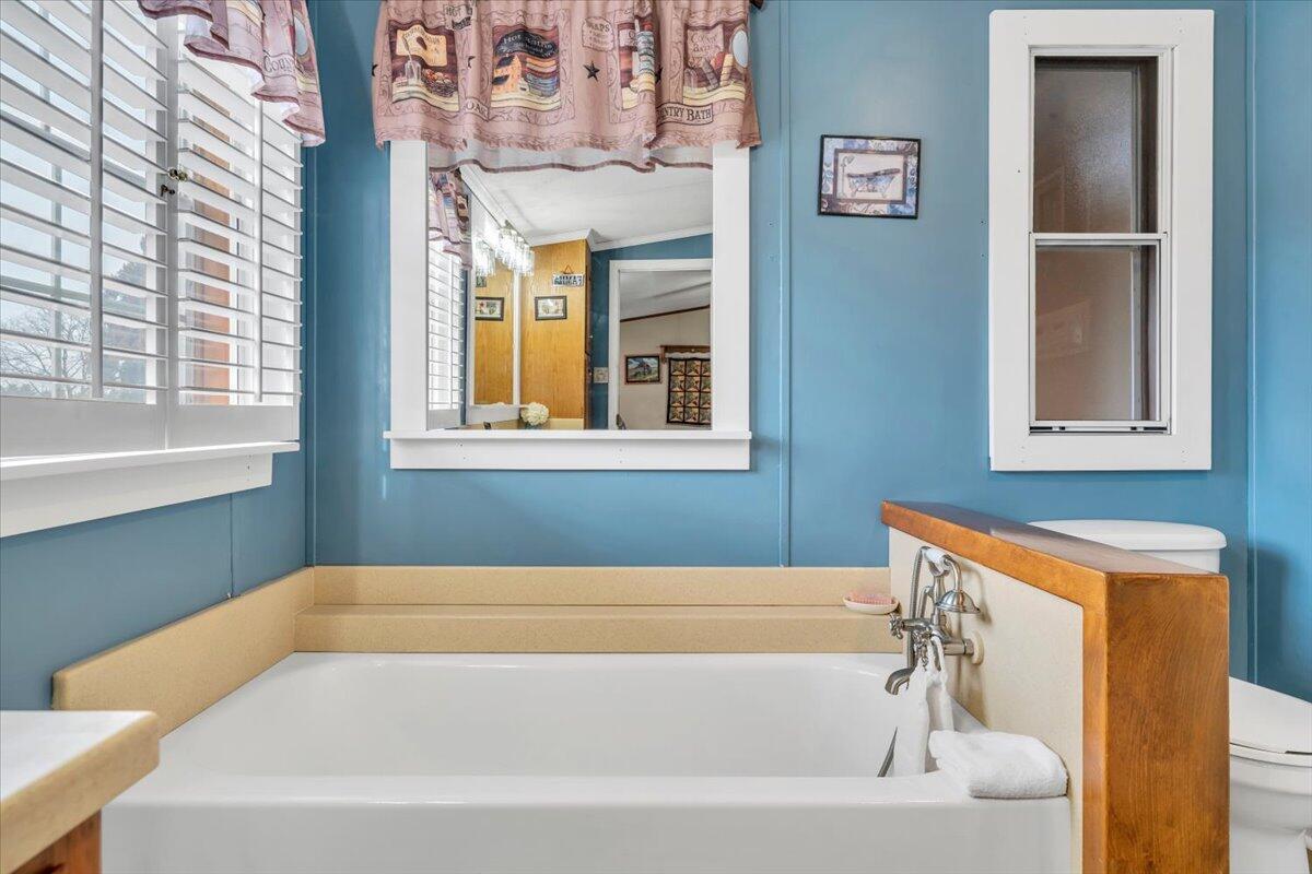 627-641 Novelty Road Penhook, VA 24137 - Photo 29 of 69 a bathroom with a bathtub and a window