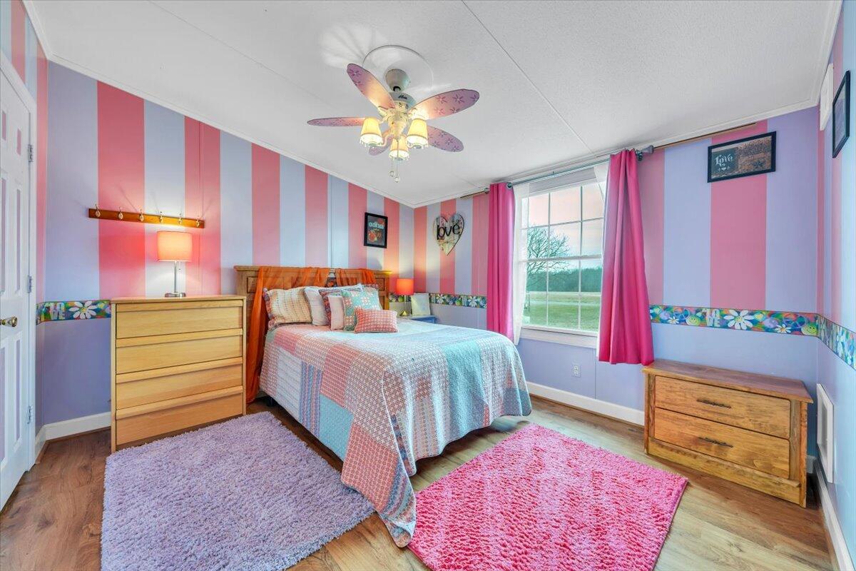 627-641 Novelty Road Penhook, VA 24137 - Photo 32 of 69 a bedroom with a bed and a chandelier