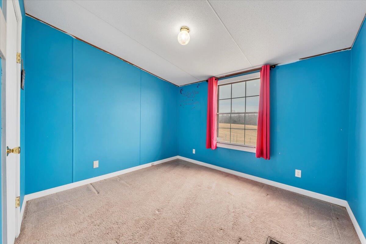 627-641 Novelty Road Penhook, VA 24137 - Photo 35 of 69 a view of empty room with window and ceiling fan
