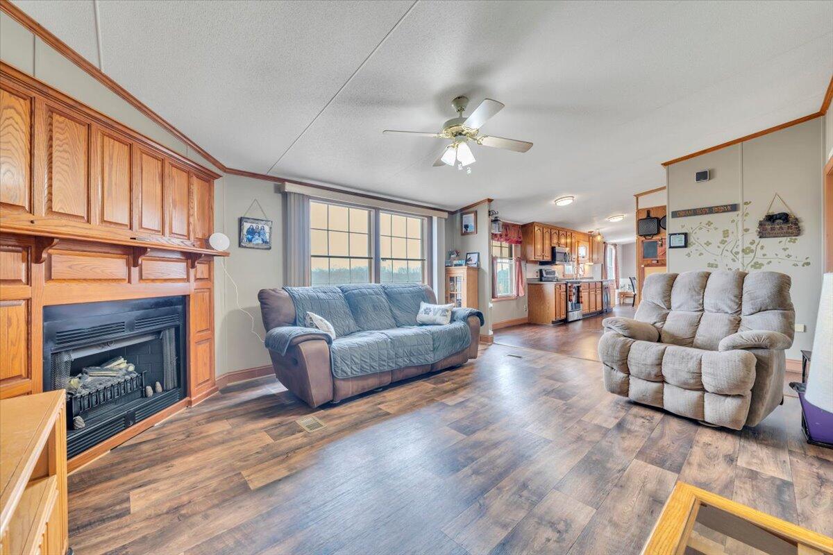 627-641 Novelty Road Penhook, VA 24137 - Photo 40 of 69 a living room with furniture a fireplace and a ceiling fan