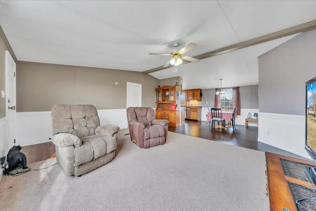 a dining room with furniture a chandelier and wooden floor