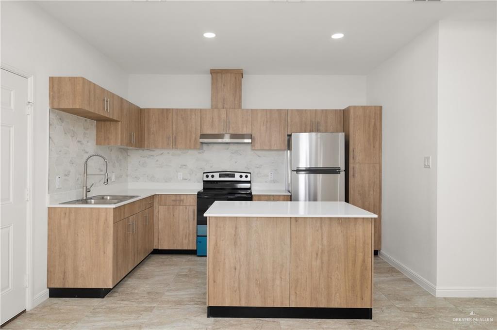 5304 Vision Street Rio Grande City, TX 78582 - Photo 12 of 26 a kitchen with stainless steel appliances a sink stove refrigerator and cabinets