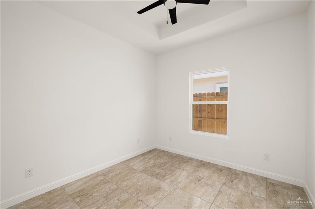 5304 Vision Street Rio Grande City, TX 78582 - Photo 16 of 26 an empty room with a window and a fan