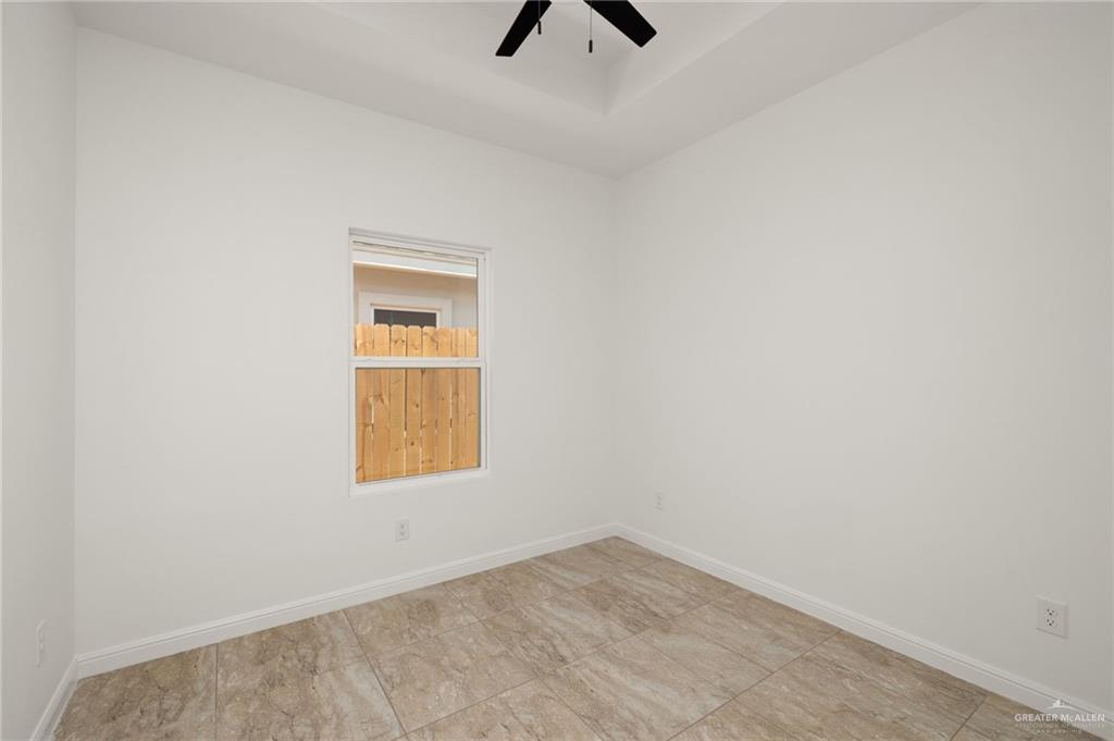 5304 Vision Street Rio Grande City, TX 78582 - Photo 18 of 26 an empty room with a window and a ceiling fan