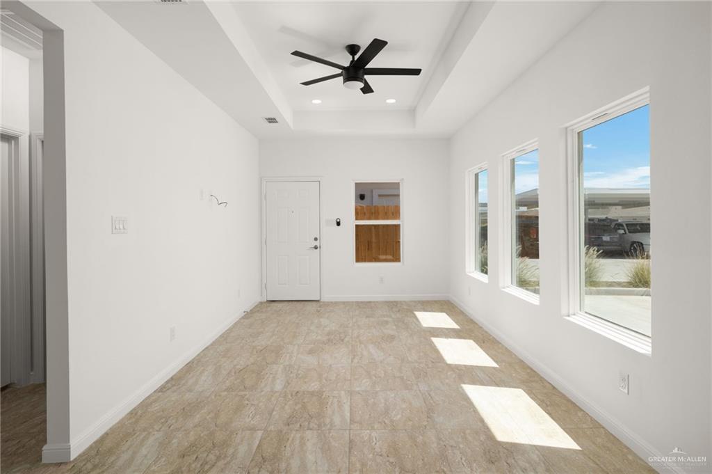 5304 Vision Street Rio Grande City, TX 78582 - Photo 2 of 26 an empty room with wooden floor and windows