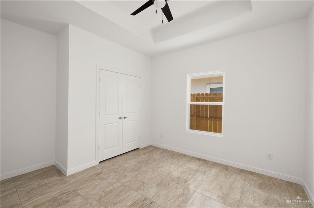 5304 Vision Street Rio Grande City, TX 78582 - Photo 6 of 26 an empty room with a window and ceiling fan
