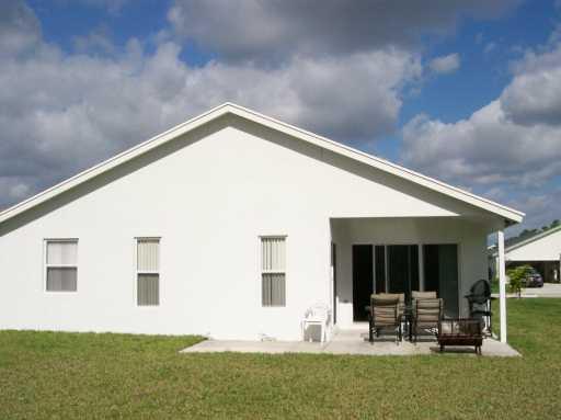2434 Southwest Malibu Way Stuart, FL 34997 - Photo 8 of 8 a house view with a garden space