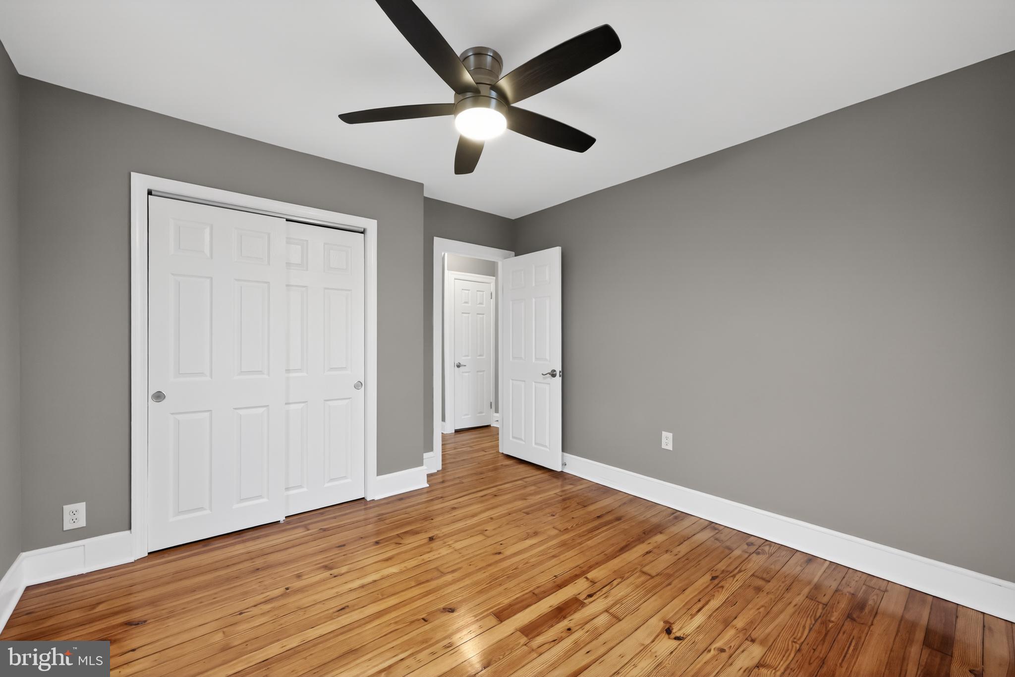 312 West Monroe Avenue Magnolia, NJ 08049 - Photo 33 of 43 an empty room with wooden floor and a ceiling fan