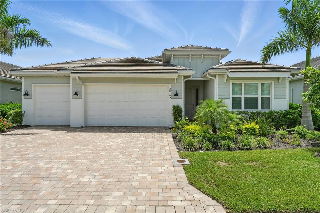 28165 Captiva Shell Loop Bonita Springs, FL 34135 - Photo 4 of 38 a front view of a house with a yard