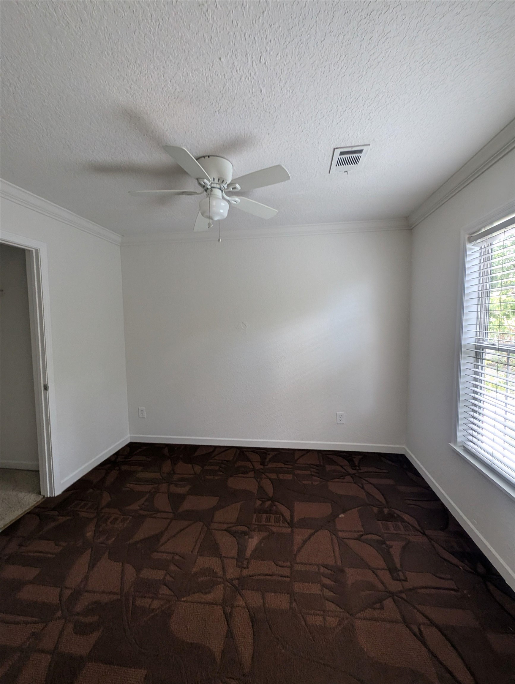 114 Cedar Street, Unit 4 St. Augustine, FL 32084 - Photo 13 of 33 an empty room with windows and fan