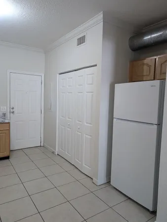 a view of a kitchen with a refrigerator
