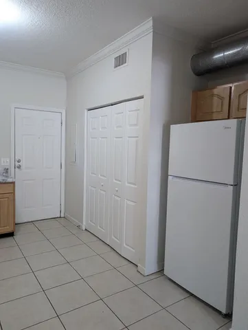 a view of a kitchen with a refrigerator