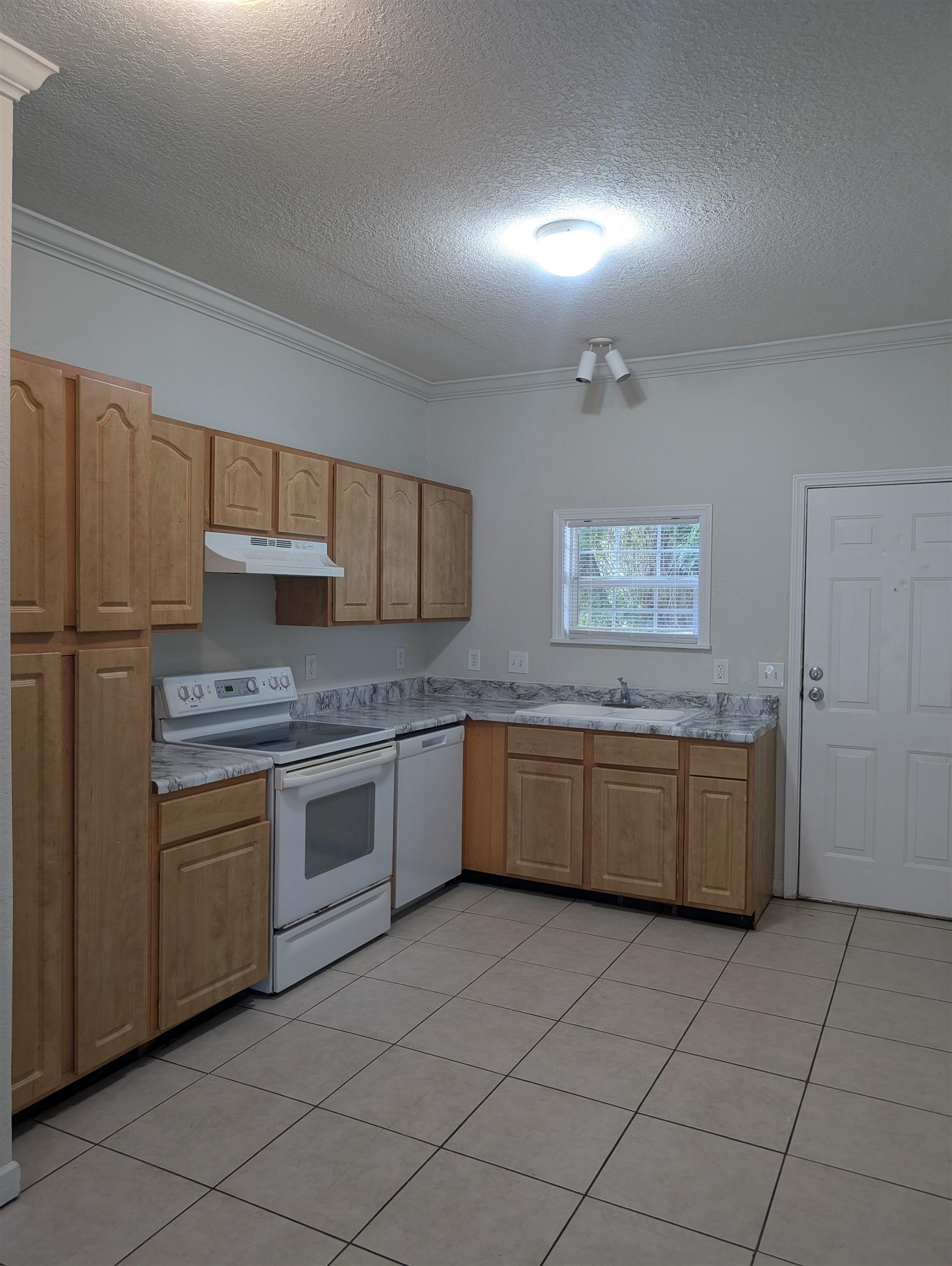 114 Cedar Street, Unit 4 St. Augustine, FL 32084 - Photo 8 of 33 a kitchen with stainless steel appliances granite countertop a stove a sink and a refrigerator