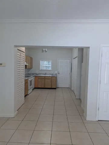 a view of a kitchen with an empty space and a window