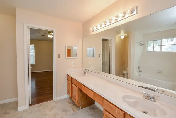 a bathroom with a double vanity sink and a mirror