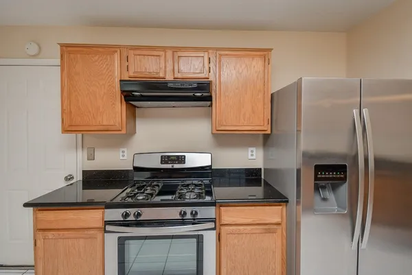 a stove top oven sitting inside of a kitchen