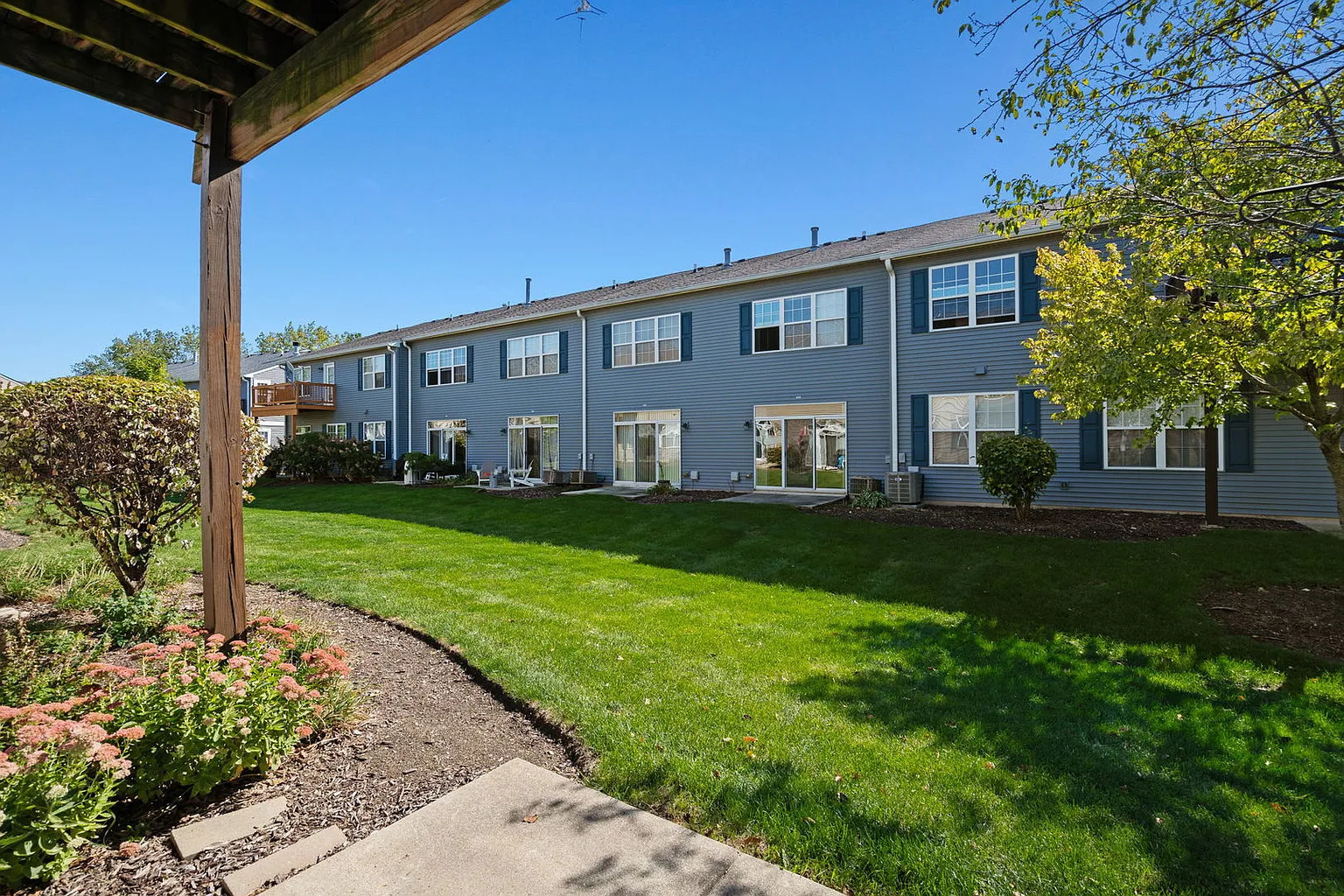 2568 Golf Ridge Circle, Unit 2568 Naperville, IL 60563 - Photo 17 of 18 a front view of a house with garden