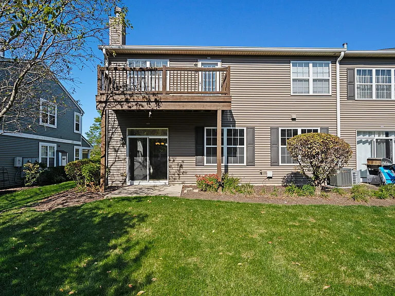 2568 Golf Ridge Circle, Unit 2568 Naperville, IL 60563 - Photo 18 of 18 a front view of a house with a garden and sitting area