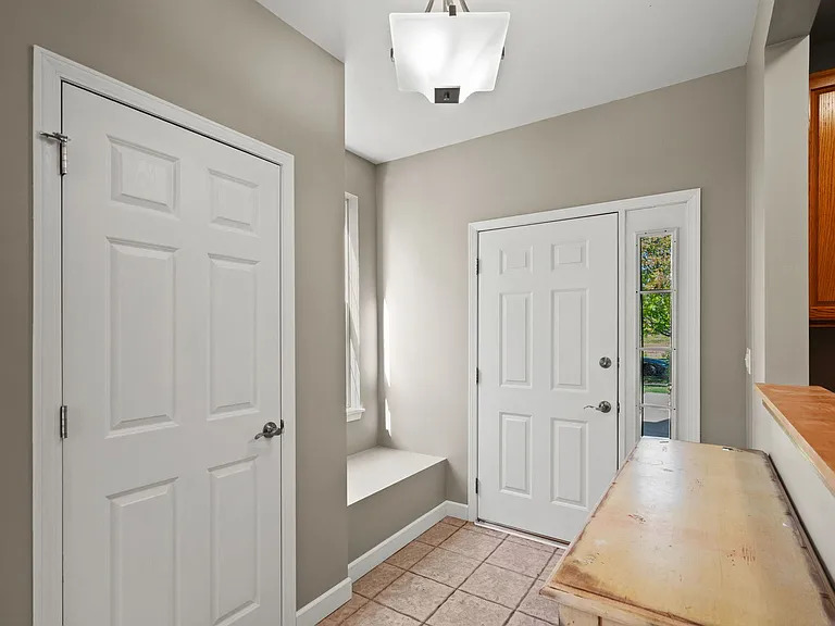 2568 Golf Ridge Circle, Unit 2568 Naperville, IL 60563 - Photo 2 of 18 a view of a hallway with wooden floor and cabinet area