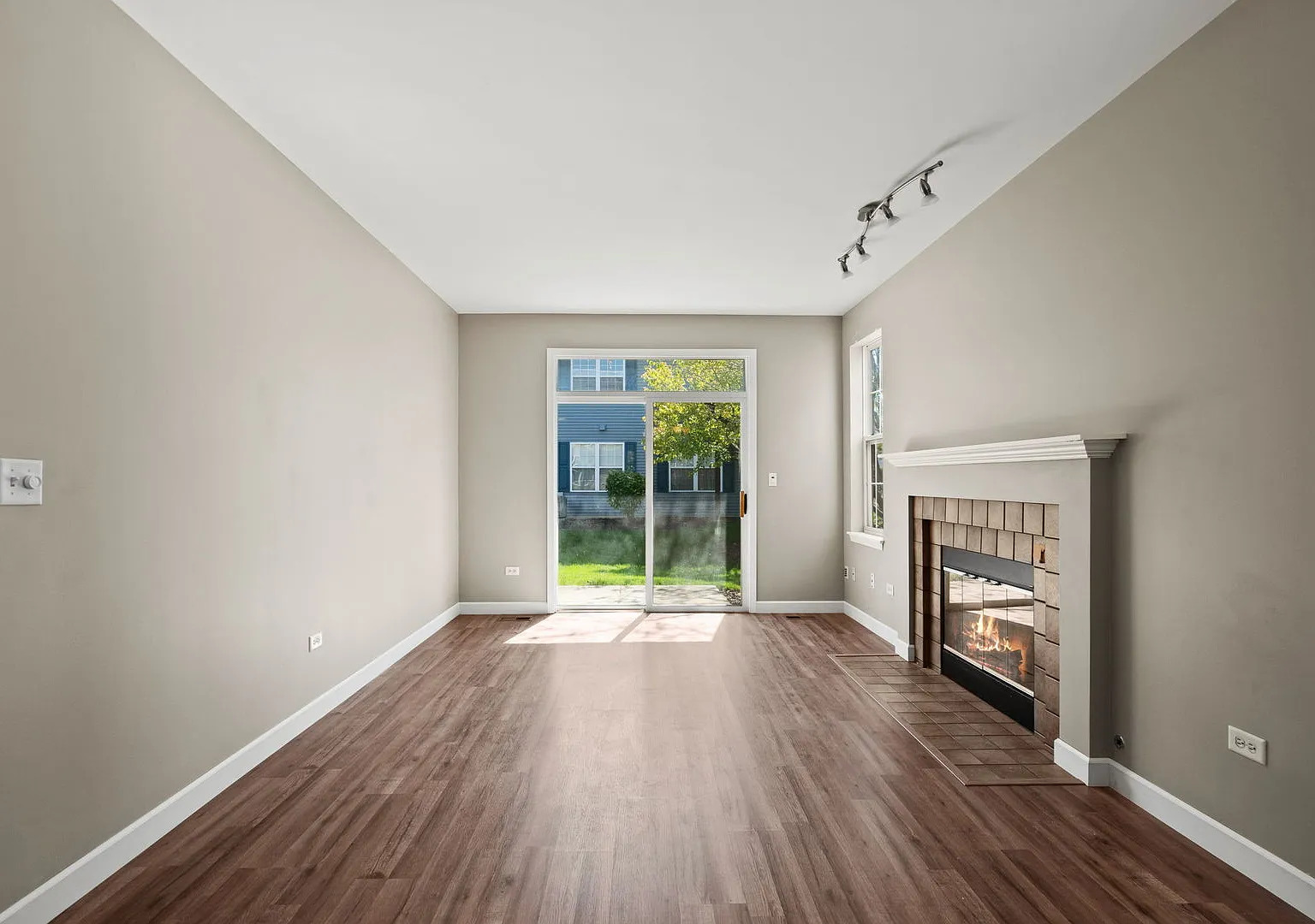 2568 Golf Ridge Circle, Unit 2568 Naperville, IL 60563 - Photo 3 of 18 a view of an empty room with a window and wooden floor