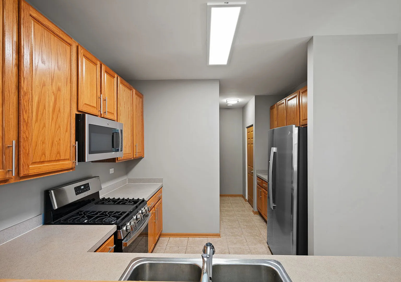 2568 Golf Ridge Circle, Unit 2568 Naperville, IL 60563 - Photo 8 of 18 a kitchen with stainless steel appliances granite countertop a refrigerator and a stove top oven
