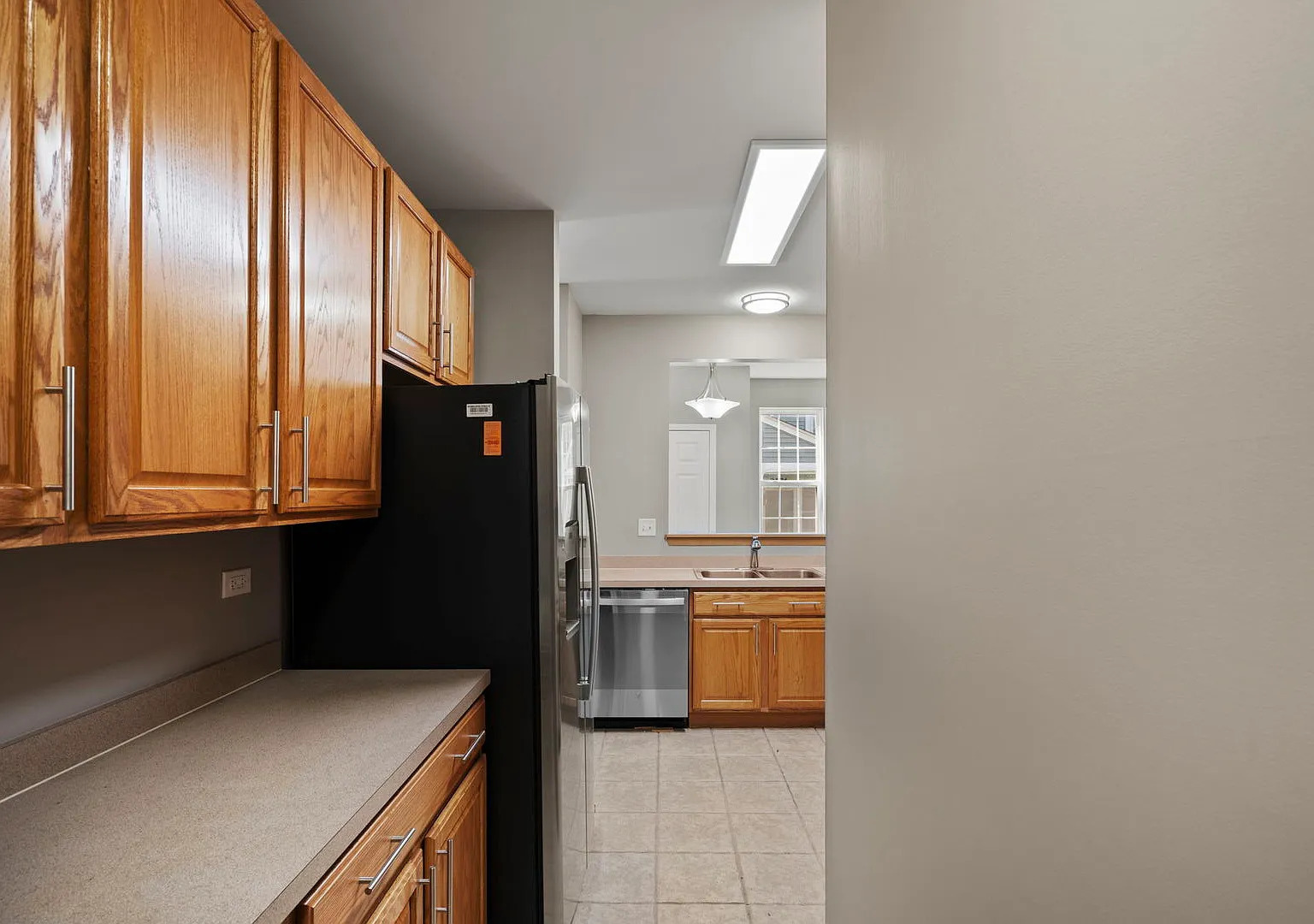 2568 Golf Ridge Circle, Unit 2568 Naperville, IL 60563 - Photo 9 of 18 a kitchen with cabinets and a refrigerator