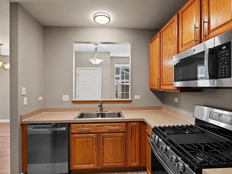 2568 Golf Ridge Circle, Unit 2568 Naperville, IL 60563 - Photo 10 of 18 a kitchen with stainless steel appliances granite countertop a stove and a sink