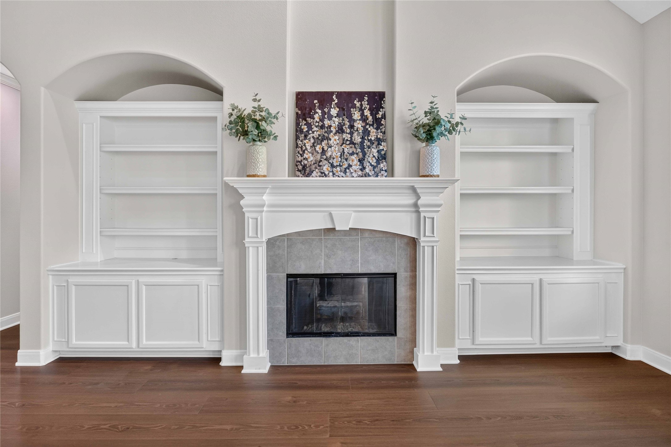 3303 Raleigh Row Missouri City, TX 77459 - Photo 12 of 50 Elegant living room featuring a beautifully crafted fireplace with built-in shelving, perfect for showcasing decor and creating a cozy ambiance.