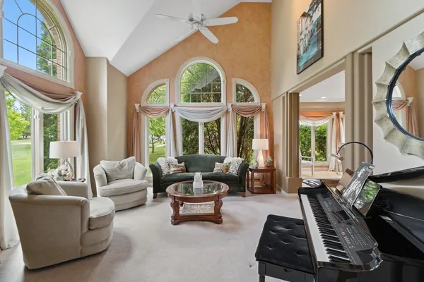 a living room with furniture fireplace and floor to ceiling windows