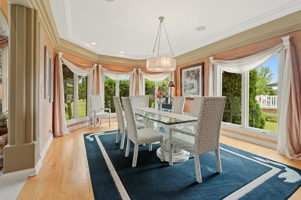 a view of a dining room with furniture wooden floor and chandelier