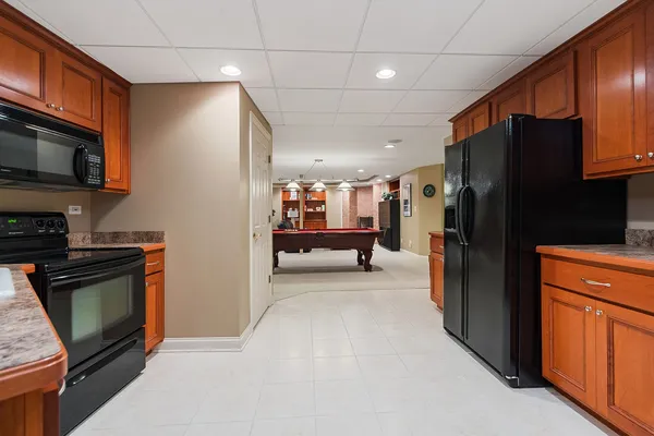 a kitchen with stainless steel appliances granite countertop a refrigerator stove and microwave
