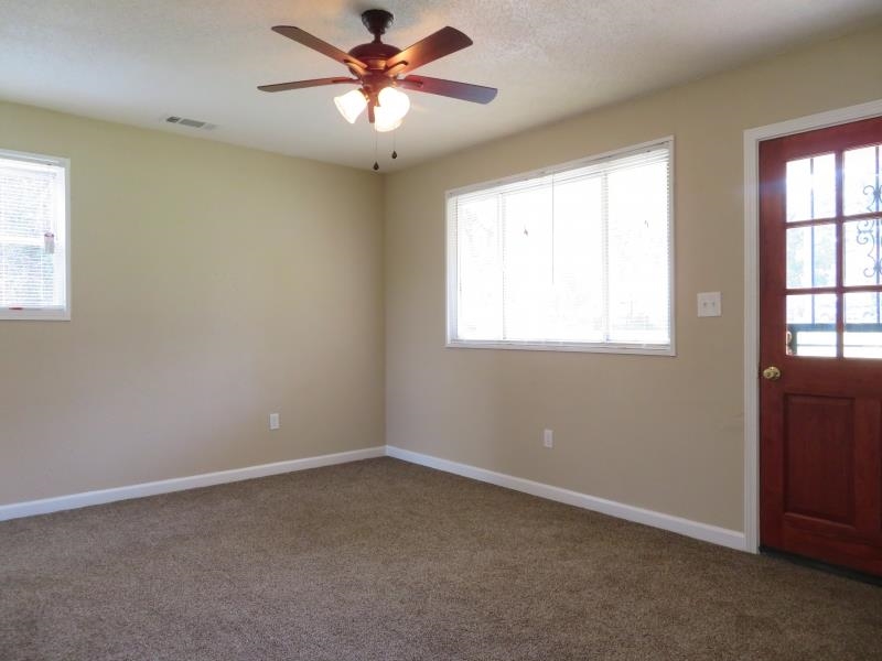 364 Elder Road Memphis, TN 38109 - Photo 6 of 11 an empty room with windows and fan