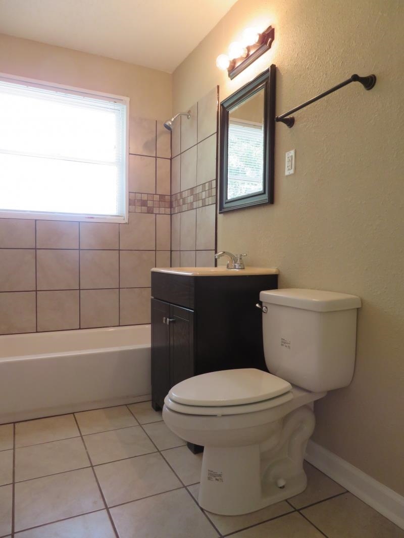 364 Elder Road Memphis, TN 38109 - Photo 8 of 11 a bathroom with a toilet a sink and bathtub