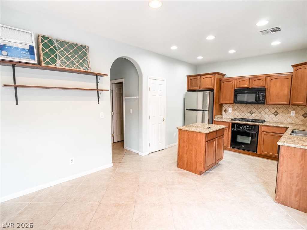 8683 Moreno Mountain Avenue Las Vegas, NV 89178 - Photo 7 of 26 A well-appointed kitchen features rich wood cabinetry and essential appliances for everyday living.