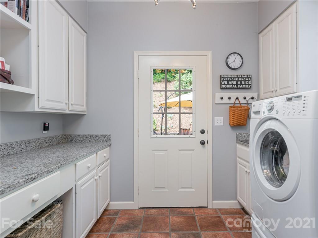 103 Windsong Drive Fairview, NC 28730 - Photo 19 of 36 a utility room with cabinets washer and dryer