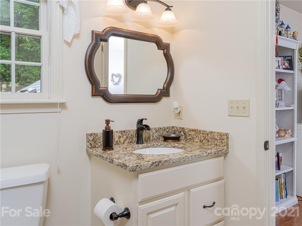 103 Windsong Drive Fairview, NC 28730 - Photo 23 of 36 a bathroom with a granite countertop sink and a mirror