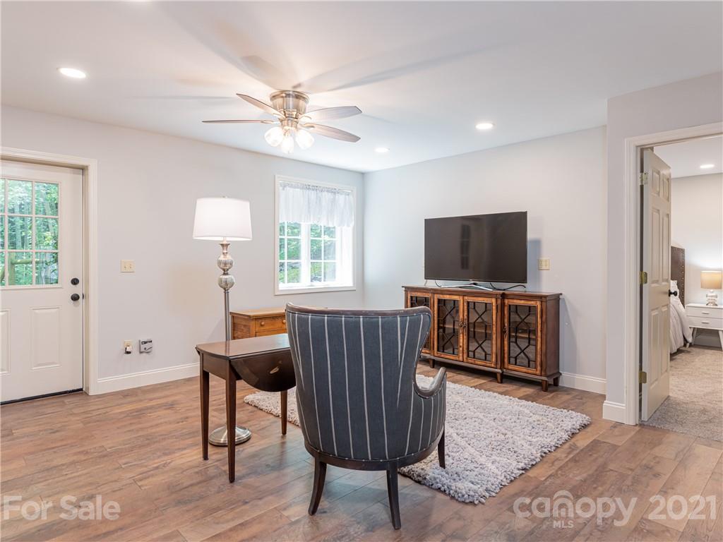 103 Windsong Drive Fairview, NC 28730 - Photo 26 of 36 a living room with furniture and a flat screen tv