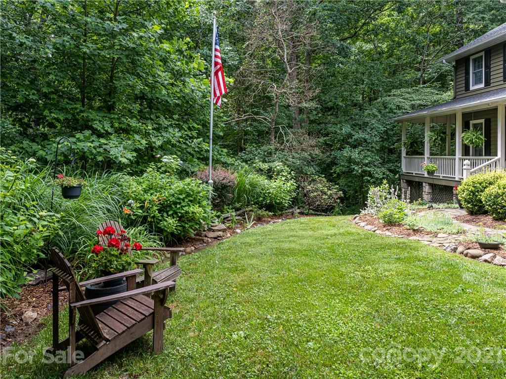 103 Windsong Drive Fairview, NC 28730 - Photo 30 of 36 a front view of a house with a yard and sitting area