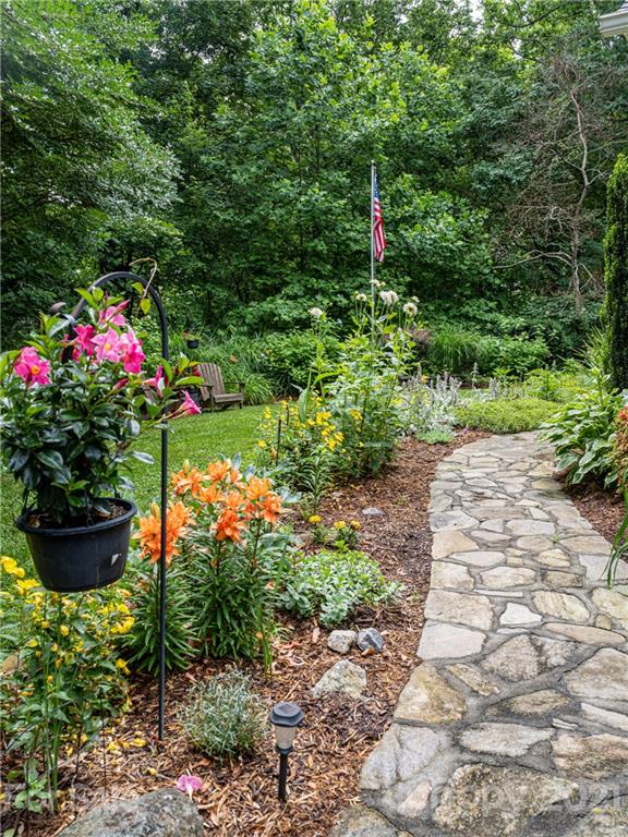 103 Windsong Drive Fairview, NC 28730 - Photo 34 of 36 a bunch of flowers are in a garden