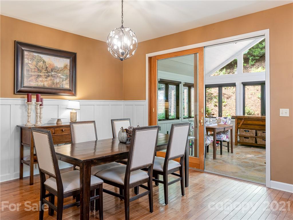 103 Windsong Drive Fairview, NC 28730 - Photo 8 of 36 a view of a dining room with furniture a chandelier and wooden floor