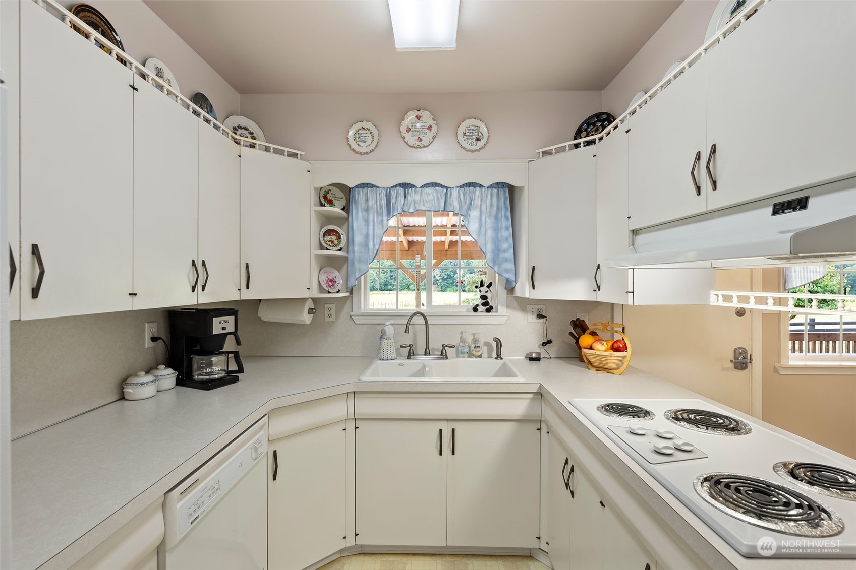 628 East Valley Road Skamokawa, WA 98647 - Photo 22 of 39 a kitchen with white cabinets and appliances
