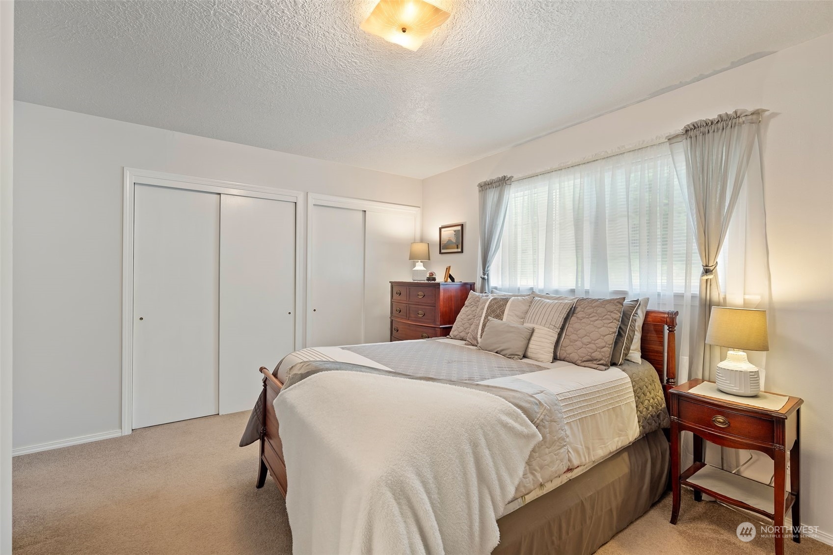 628 East Valley Road Skamokawa, WA 98647 - Photo 28 of 39 a bedroom with a bed and a chandelier