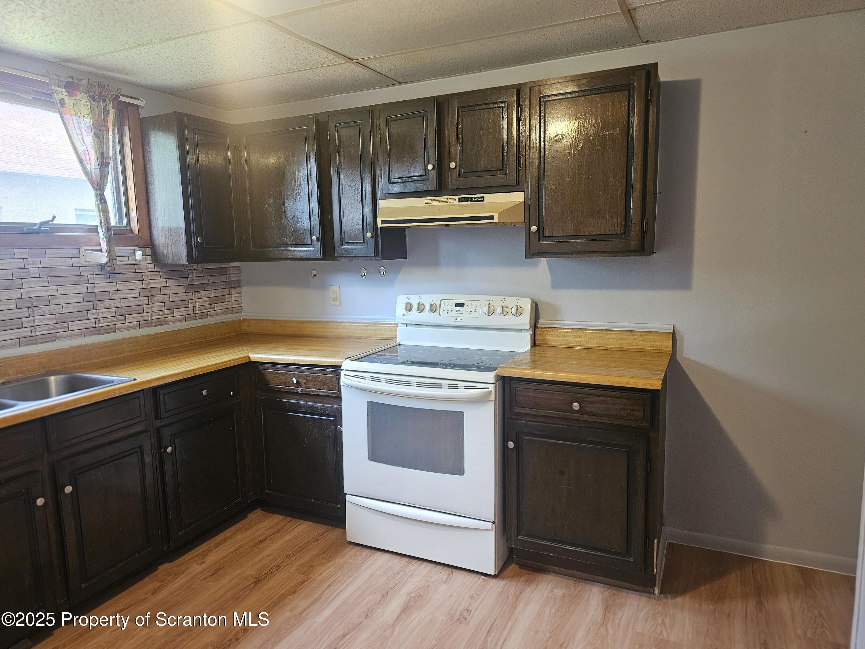 a kitchen with a sink cabinets and appliances