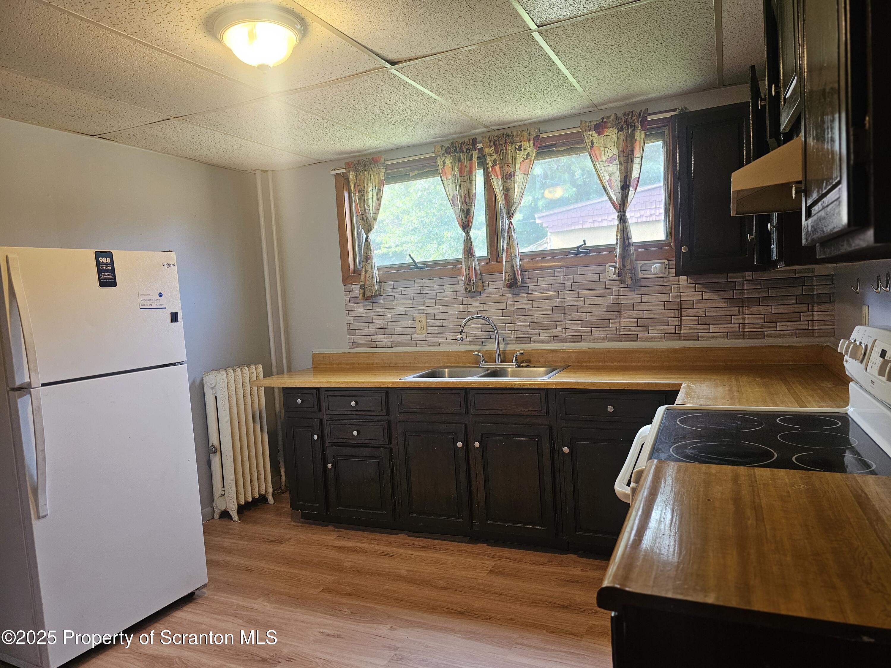 510 Front Street, Unit 1E Scranton, PA 18505 - Photo 2 of 5 a kitchen with stainless steel appliances granite countertop a refrigerator and a sink