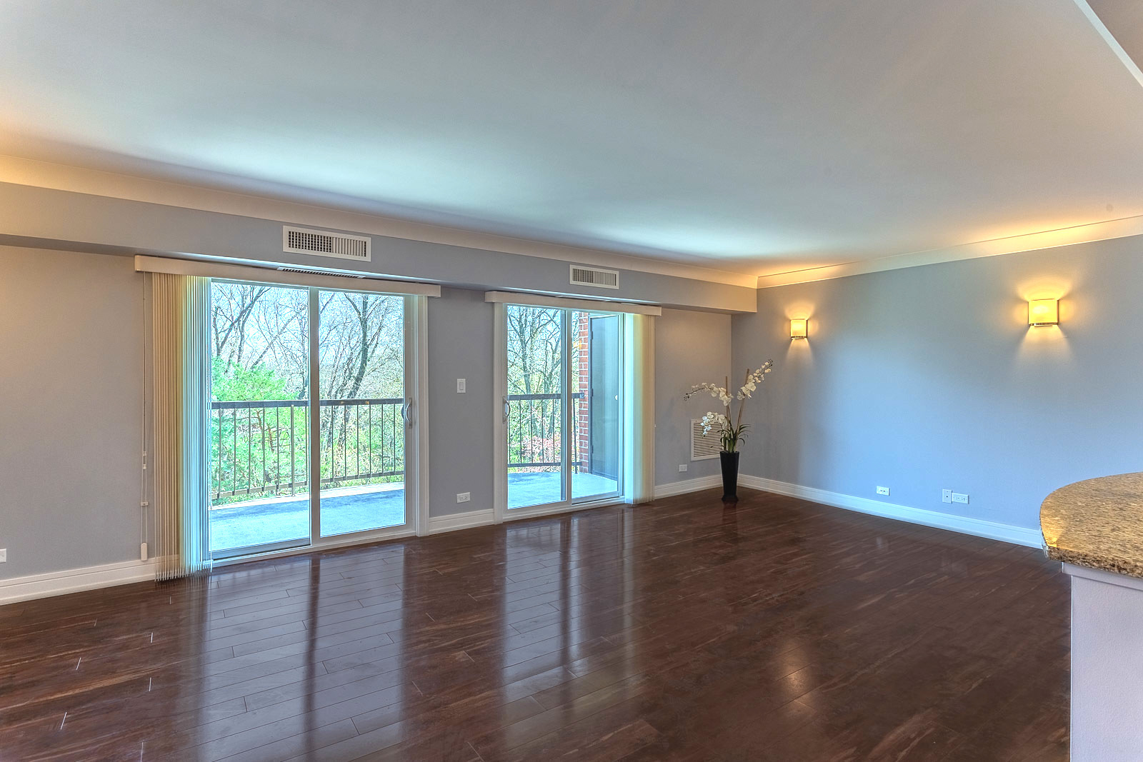 1615 East Central Road, Unit 401A Arlington Heights, IL 60005 - Photo 2 of 18 a view of an empty room with wooden floor and a window