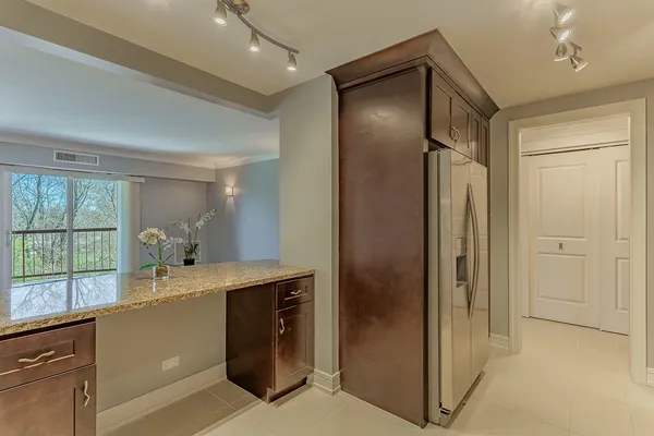 a room with a refrigerator and a sink