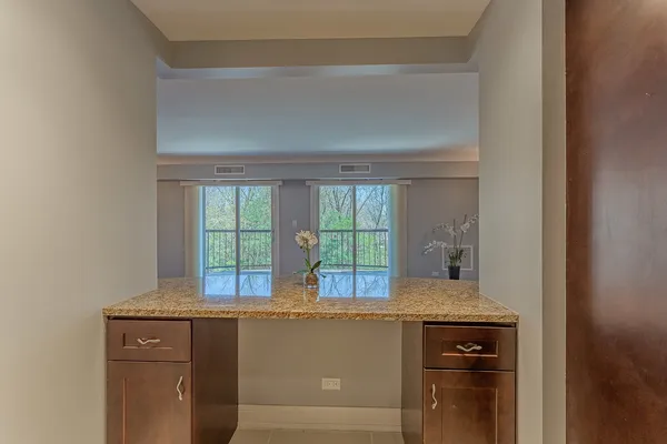 a kitchen with granite countertop a sink a stove and cabinets